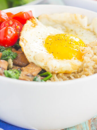 Switch up your breakfast routine with this Savory Oatmeal Breakfast Bowl. Filled with hearty oats, fresh mushrooms, sauteed spinach and an egg, this simple dish is packed with flavor and is the perfect way to start the day!