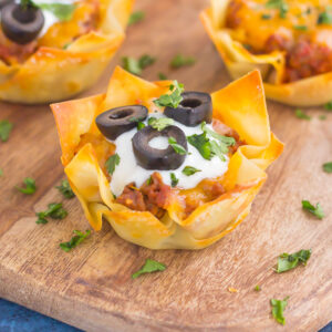 These Cheesy Taco Cups are the perfect game day snack. Your favorite taco ingredients are layered in wonton wrappers and baked in mini form. Easy to make and even better to eat, you'll enjoy these handheld cups that are packed with so much flavor!