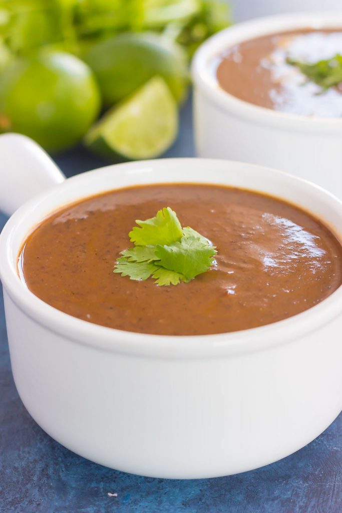 A bowl of easy black bean soup in a white ramekin. 