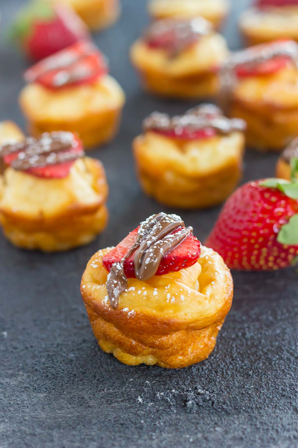 nutella stuffed pancake bites topped with strawberry slices and nutella