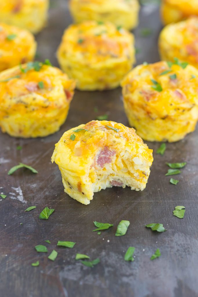 hash brown cups in rows. the front cup has a bite missing. 