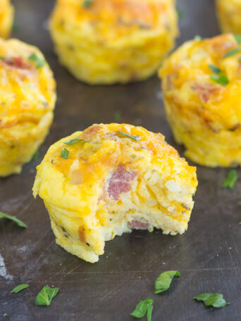 Filled with eggs, cheddar cheese, bacon, and hash browns, these Cheesy Egg and Hash Brown Cups are pop-able, and delicious for a quick breakfast on-the-go!