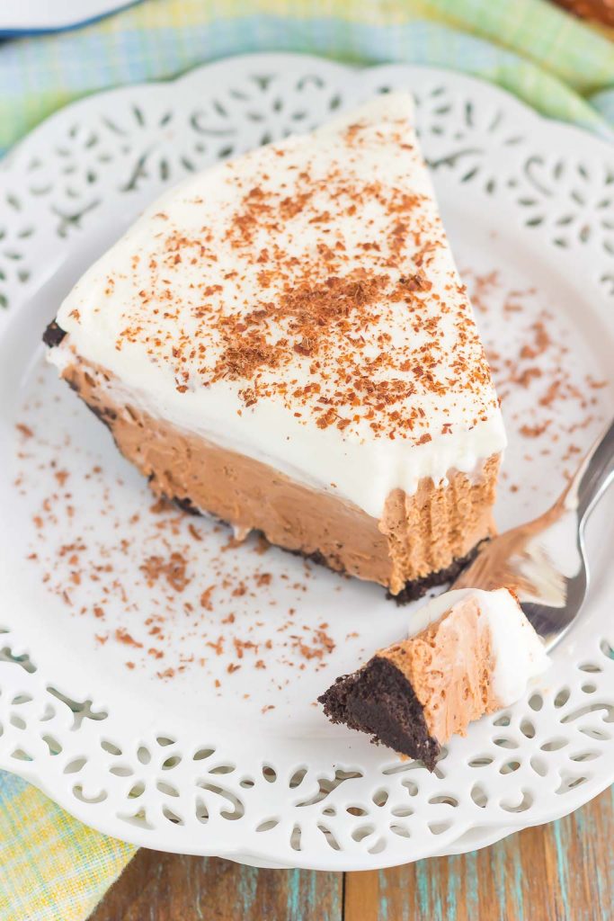 slice of nutella pie on a white plate. a fork with a bite of pie rests on the plate too. 