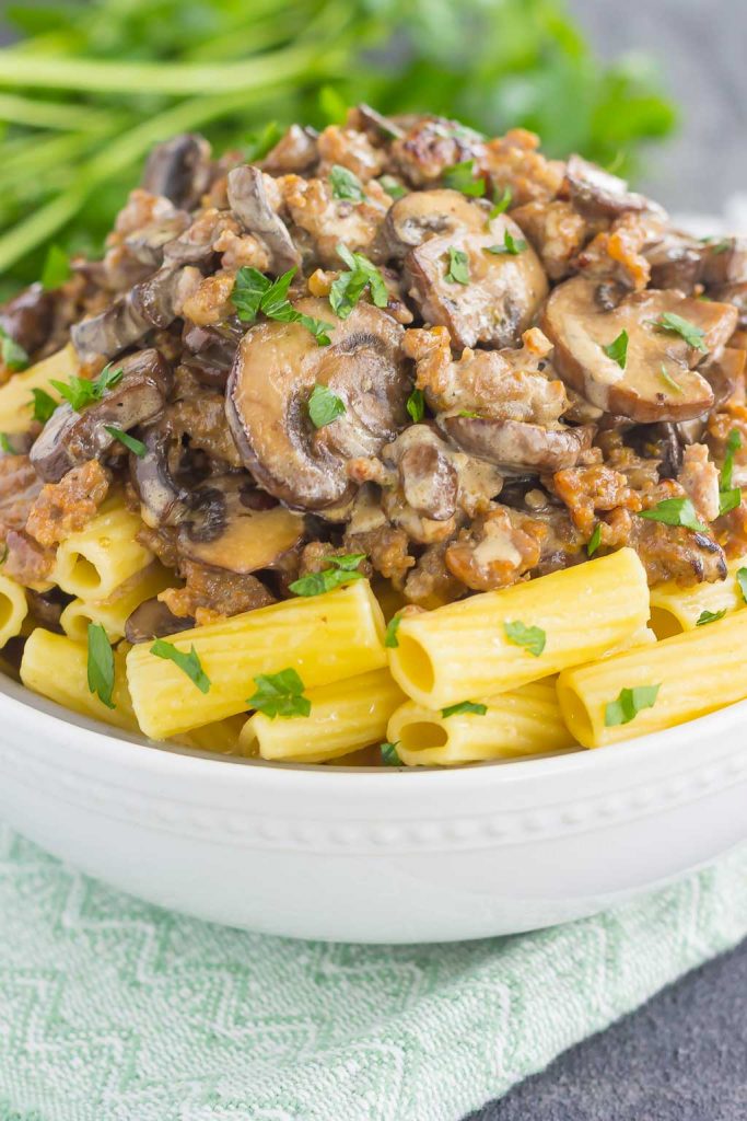 This Creamy Sausage and Mushroom Rigatoni is the perfect comfort dish that's ready in just 30 minutes. Zesty sausage, fresh mushrooms and rigatoni pasta are tossed in flavorful cream sauce. Hearty, comforting, and all-around delicious, this meal-time favorite is sure to be a winner all year long! #sausage #rigatoni #mushrooms #mushroomrigatoni #sausagerigatoni #skillet #skilletmeal #skilletdinner #pasta #pastaskilet #dinner