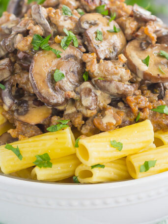 This Creamy Sausage and Mushroom Rigatoni is the perfect comfort dish that's ready in just 30 minutes. Zesty sausage, fresh mushrooms and rigatoni pasta are tossed in flavorful cream sauce. Hearty, comforting, and all-around delicious, this meal-time favorite is sure to be a winner all year long!