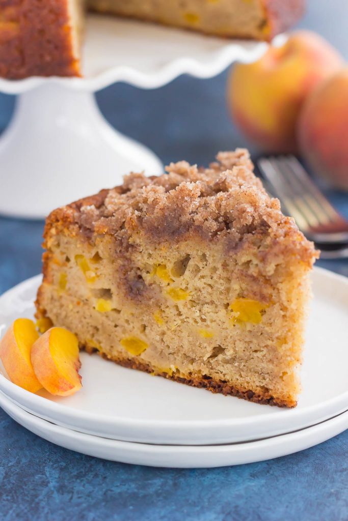 slice of peach crumb cake on white plate