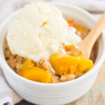 This Slow Cooker Peach Cobbler is loaded with juicy peaches, a sprinkling of cozy spices, and layered with a crispy, cakey topping. Just throw everything into the slow cooker, set it, and forget it. In just a few hours, you'll have a warm and flavorful dessert ready to be devoured!