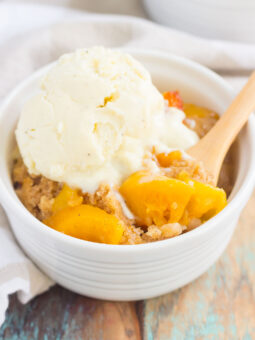 This Slow Cooker Peach Cobbler is loaded with juicy peaches, a sprinkling of cozy spices, and layered with a crispy, cakey topping. Just throw everything into the slow cooker, set it, and forget it. In just a few hours, you'll have a warm and flavorful dessert ready to be devoured!