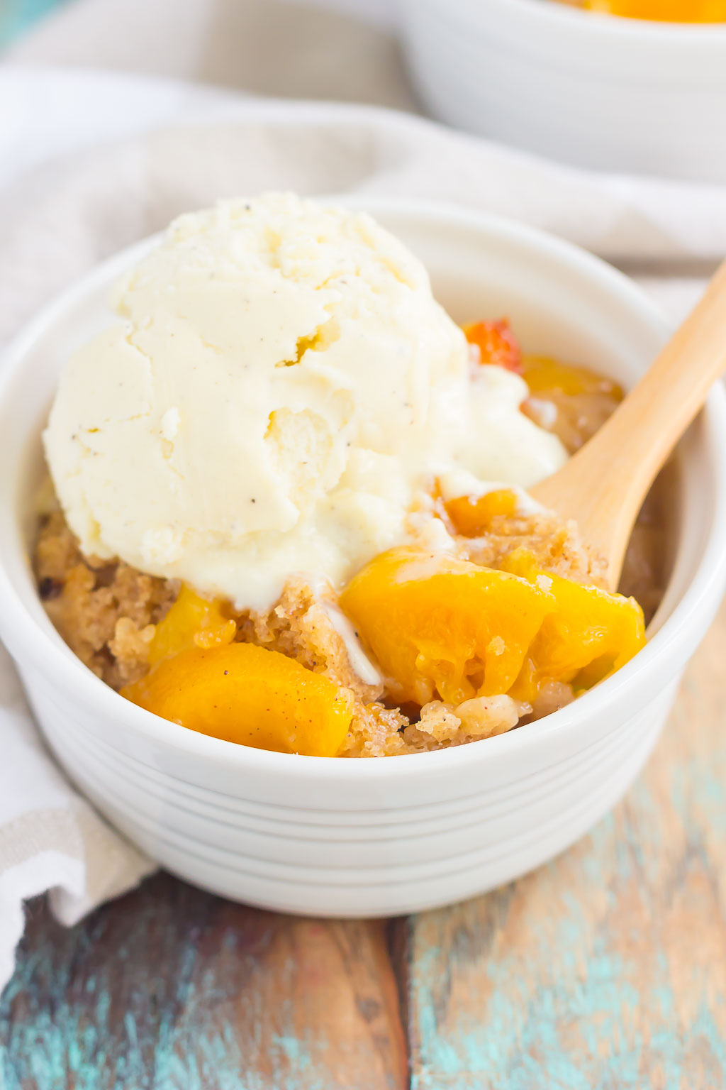 This Slow Cooker Peach Cobbler is loaded with juicy peaches, a sprinkling of cozy spices, and layered with a crispy, cakey topping. Just throw everything into the slow cooker, set it, and forget it. In just a few hours, you'll have a warm and flavorful dessert ready to be devoured!
