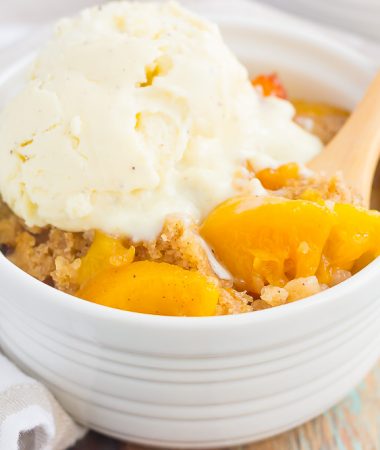 This Slow Cooker Peach Cobbler is loaded with juicy peaches, a sprinkling of cozy spices, and layered with a crispy, cakey topping. Just throw everything into the slow cooker, set it, and forget it. In just a few hours, you'll have a warm and flavorful dessert ready to be devoured!