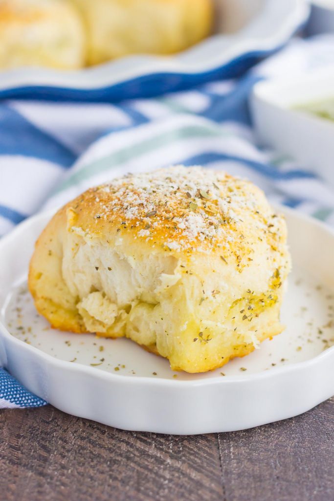 These Stuffed Cheesy Pesto Rolls are an easy dish to make for those hungry dinner guests. Soft and buttery rolls are filled with pesto sauce and mozzarella cheese, and then baked until golden. Crispy on the outsize and oozing with flavor on the inside, this simple roll is sure to wow even the pickiest of eaters!