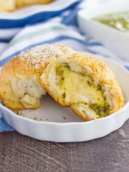 These Stuffed Cheesy Pesto Rolls are an easy dish to make for those hungry dinner guests. Soft and buttery rolls are filled with pesto sauce and mozzarella cheese, and then baked until golden. Crispy on the outsize and oozing with flavor on the inside, this simple roll is sure to wow even the pickiest of eaters!