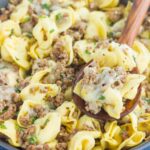 This Cheesy Beef Tortellini Skillet is a simple, one pan meal that's bursting with flavor. Loaded with ground beef, spices, tortellini, and cheese, this easy meal is family-friendly and so delicious!