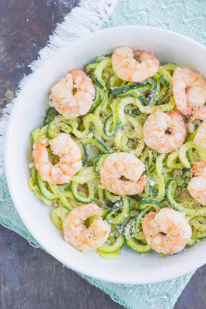 overhead view of parmesan zoodles with shrimp in a white bowl 