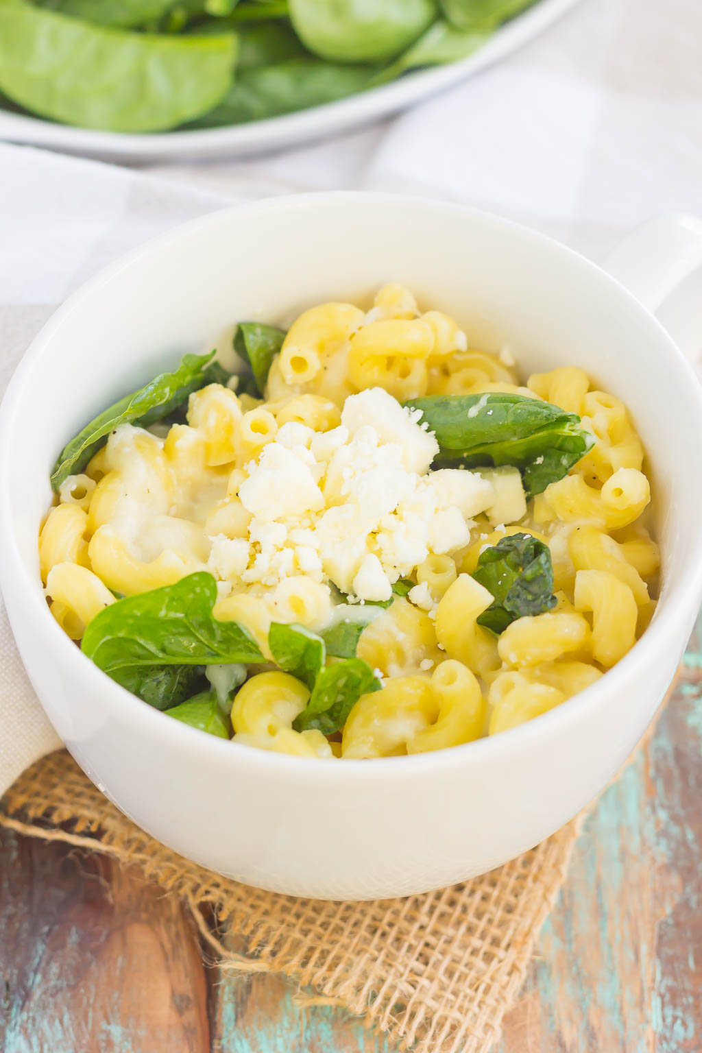 All it takes is just one mug and 5 minutes to make this Microwave Mug Spinach and Feta Macaroni and Cheese. Tender pasta, mozzarella and feta cheeses and a sprinkling of spinach create an easy, cheesy, and oh-so delicious single serving recipe for the best macaroni and cheese!