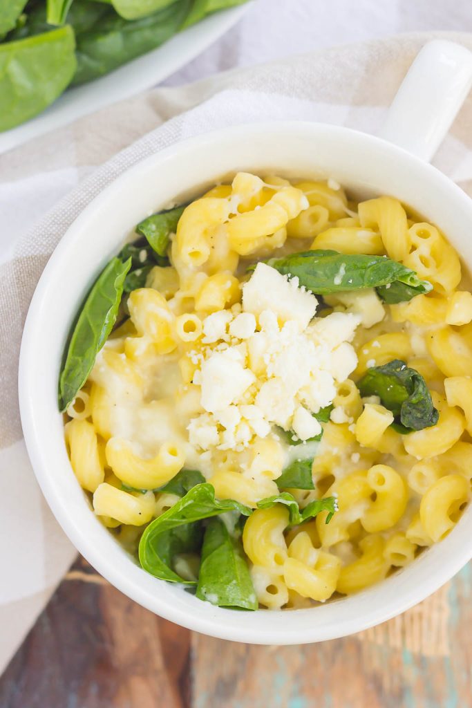 All it takes is just one mug and 5 minutes to make this Microwave Mug Spinach and Feta Macaroni and Cheese. Tender pasta, mozzarella and feta cheeses and a sprinkling of spinach create an easy, cheesy, and oh-so delicious single serving recipe for the best macaroni and cheese!