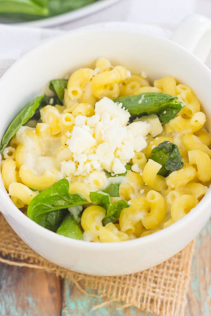 All it takes is just one mug and 5 minutes to make this Microwave Mug Spinach and Feta Macaroni and Cheese. Tender pasta, mozzarella and feta cheeses and a sprinkling of spinach create an easy, cheesy, and oh-so delicious single serving recipe for the best macaroni and cheese!