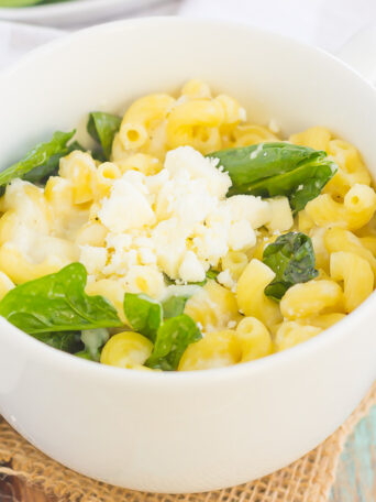 All it takes is just one mug and 5 minutes to make this Microwave Mug Spinach and Feta Macaroni and Cheese. Tender pasta, mozzarella and feta cheeses and a sprinkling of spinach create an easy, cheesy, and oh-so delicious single serving recipe for the best macaroni and cheese!