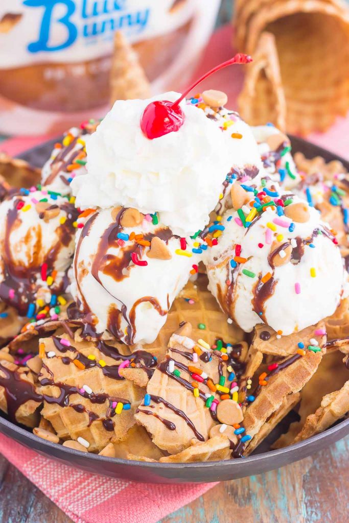 Peanut Butter Ice Cream Sundae Nachos are a deliciously sweet treat for everyone to enjoy. Crunchy waffle cones are sprinkled with sweet ice cream and all of the fun, sundae toppings. Easy to make and and even better to eat, these nachos make the best dessert during the warmer months!