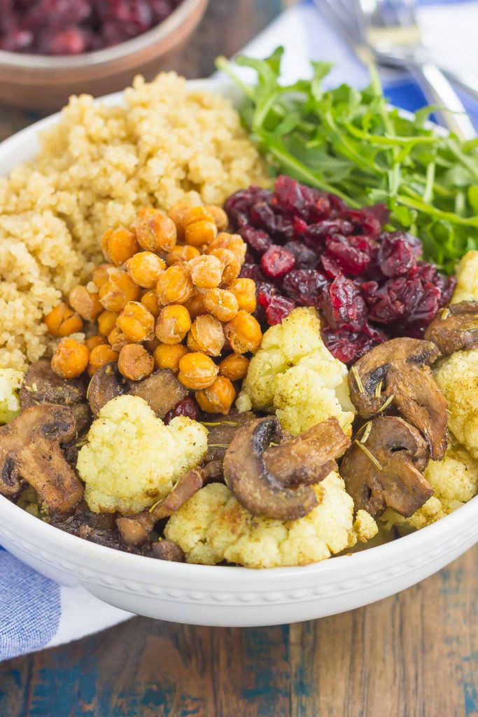 This Roasted Cauliflower, Mushroom and Chickpea Quinoa Bowl is a quick and easy meatless meal that is sure to please everyone. Hearty quinoa is tossed with roasted cauliflower, mushrooms, chickpeas, and arugula, all tossed in a savory white balsamic dressing. This healthier meal is ready in just 30 minutes and packed with delicious superfoods!