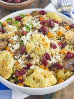 This Roasted Cauliflower, Mushroom and Chickpea Quinoa Bowl is a quick and easy meatless meal that is sure to please everyone. Hearty quinoa is tossed with roasted cauliflower, mushrooms, chickpeas, and arugula, all tossed in a savory white balsamic dressing. This healthier meal is ready in just 30 minutes and packed with delicious superfoods!