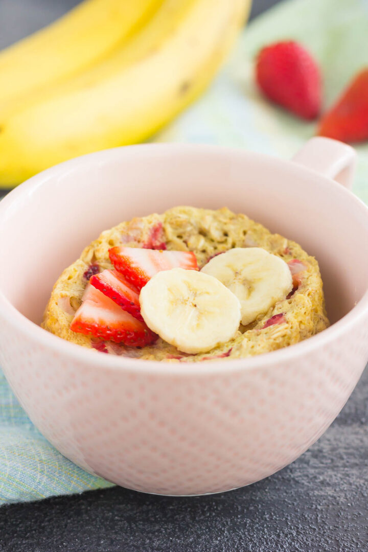 Strawberry banana microwave baked oatmeal in a small pink bowl.