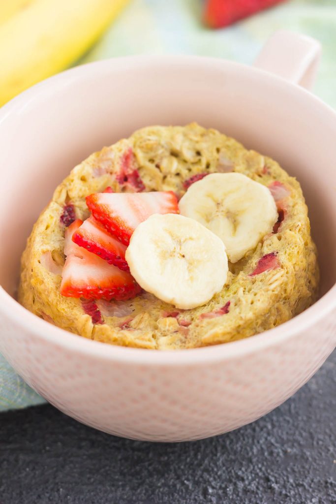 Strawberry banana microwave baked oatmeal in a small pink bowl. 