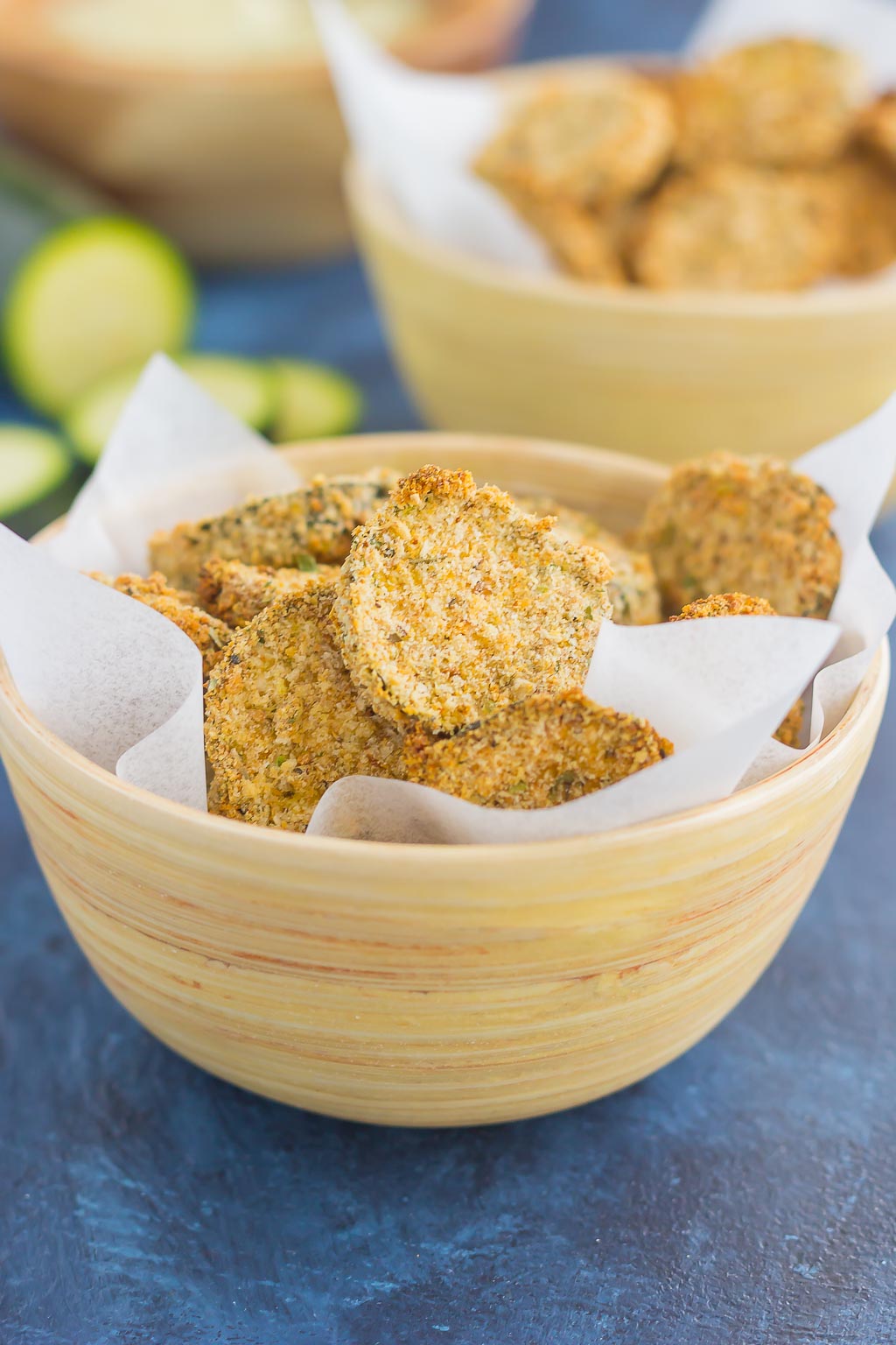 two bowls of baked zucchini chips 