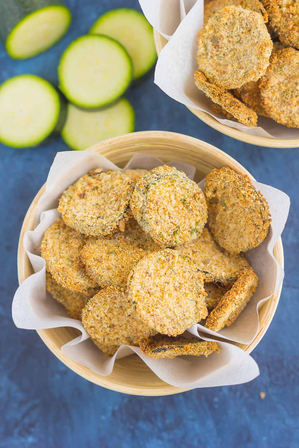 overhead view of two bowls of baked zucchini chips