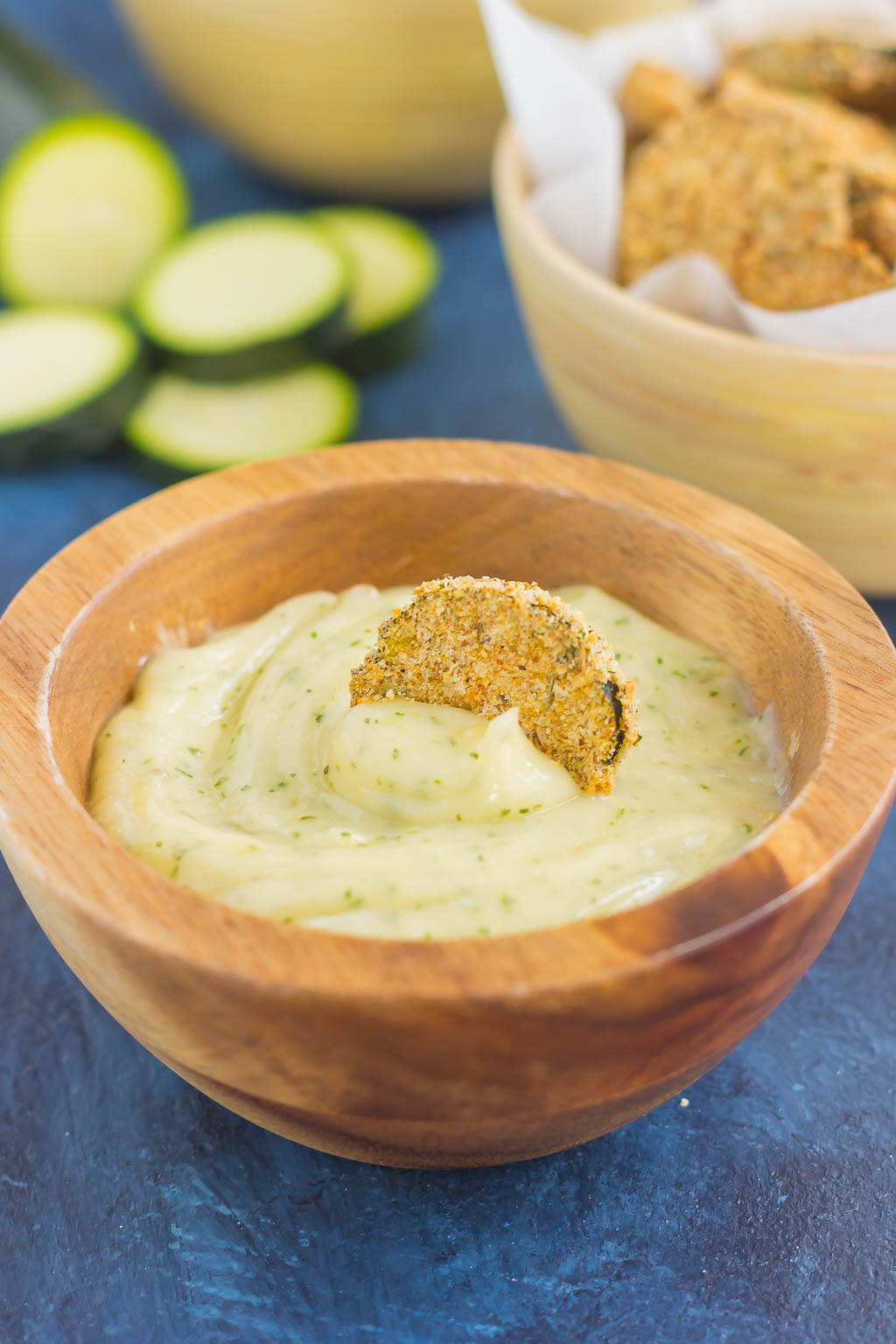 one zucchini chip in bowl of ranch mayo dip