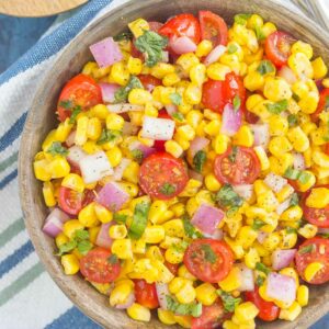 With fresh corn cut straight from the cob, cherry tomatoes, spices, and a light dressing, this Corn and Tomato Salad is perfect for a summer lunch or dinner!