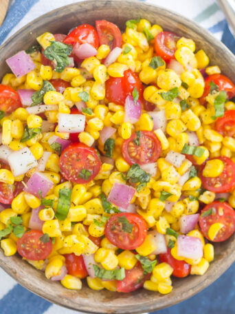 With fresh corn cut straight from the cob, cherry tomatoes, spices, and a light dressing, this Corn and Tomato Salad is perfect for a summer lunch or dinner!