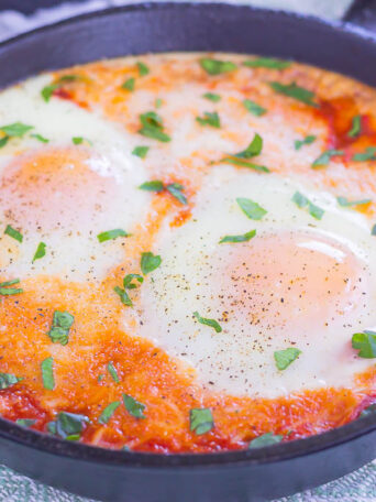 These Marinara Baked Eggs make an easy and hearty meal for busy mornings. Perfect alongside toast, garlic bread, or on its own, this dish is sure to be a favorite all year long!