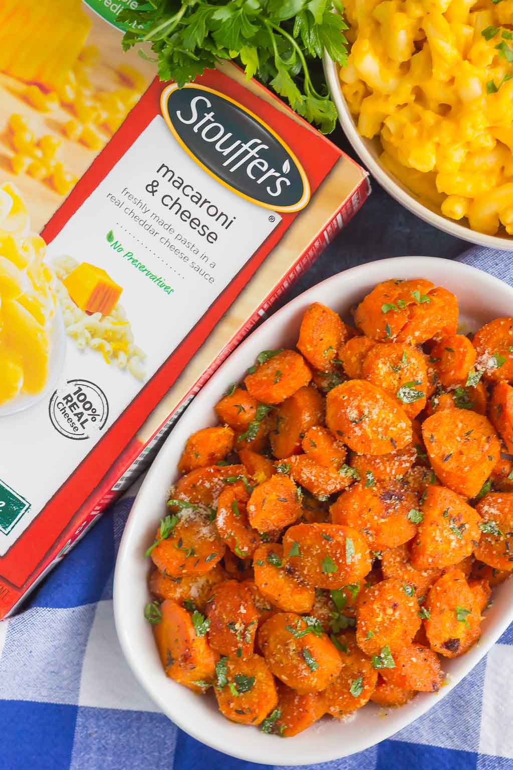 Overhead view of a dish of roasted honey glazed carrots next to a box of Stouffer's mac and cheese.