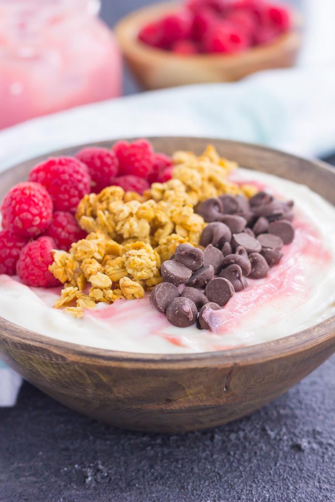 This Raspberry Grapefruit Yogurt Bowl is a delicious way to start the day. It's packed with creamy vanilla Greek yogurt, a swirl of raspberry grapefruit curd, and topped with a combination of sweet ingredients. Fresh, flavorful, and light, this is the best way to switch up your breakfast or snack routine!