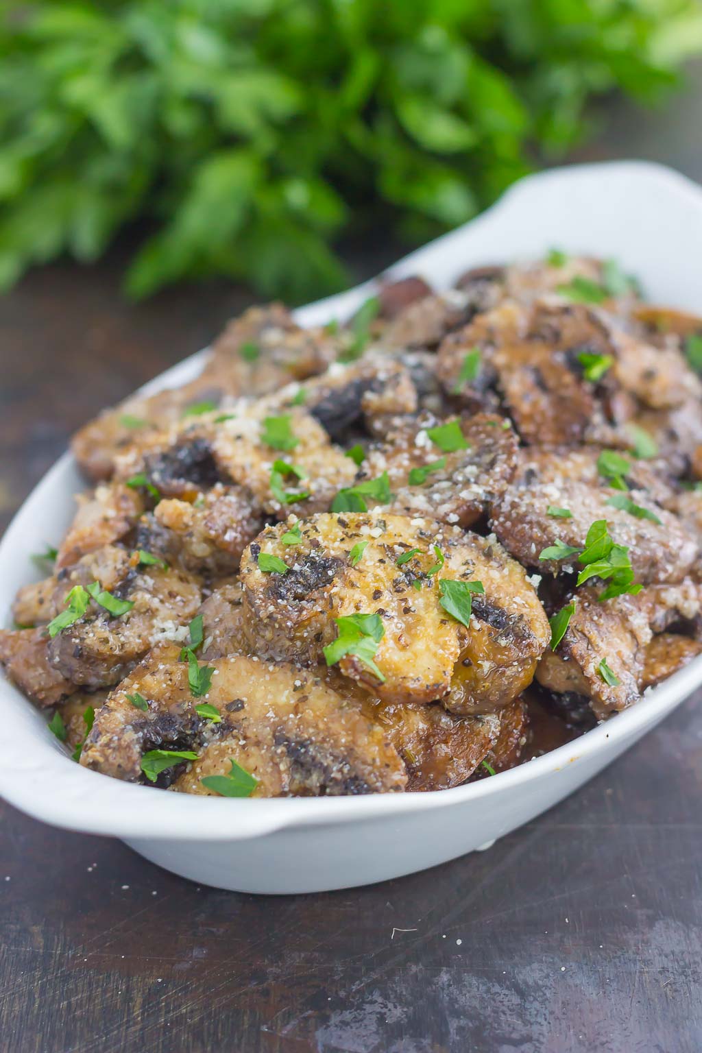 These Baked Parmesan Garlic Mushrooms are seasoned to perfection with garlic, basil, and Parmesan cheese. Easy to prepare and even better to eat, you will be making this side dish all the time!