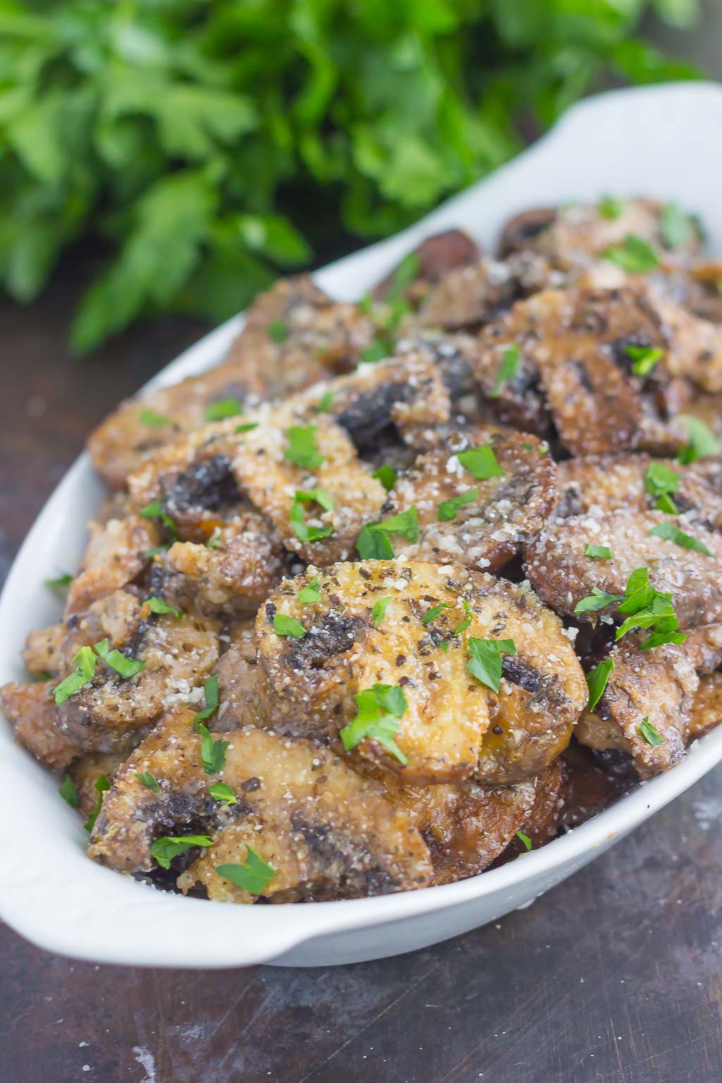 These Baked Parmesan Garlic Mushrooms are seasoned to perfection with garlic, basil, and Parmesan cheese. Easy to prepare and even better to eat, you will be making this side dish all the time!