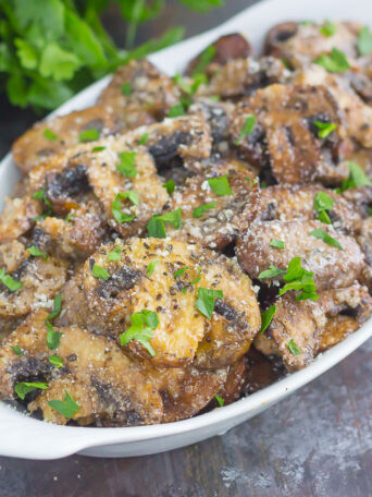 These Baked Parmesan Garlic Mushrooms are seasoned to perfection with garlic, basil, and Parmesan cheese. Easy to prepare and even better to eat, you will be making this side dish all the time!