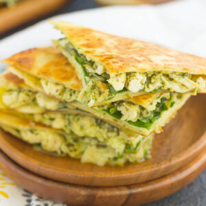 These Chicken and Spinach Pesto Quesadillas are simple to make and ready in less than 20 minutes. Filled with shredded chicken, pesto, baby spinach, and mozzarella cheese, this easy dish is packed with flavor and perfect for busy weeknights!