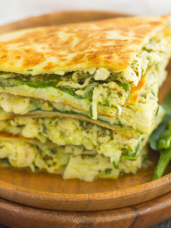 These Chicken and Spinach Pesto Quesadillas are simple to make and ready in less than 20 minutes. Filled with shredded chicken, pesto, baby spinach, and mozzarella cheese, this easy dish is packed with flavor and perfect for busy weeknights!