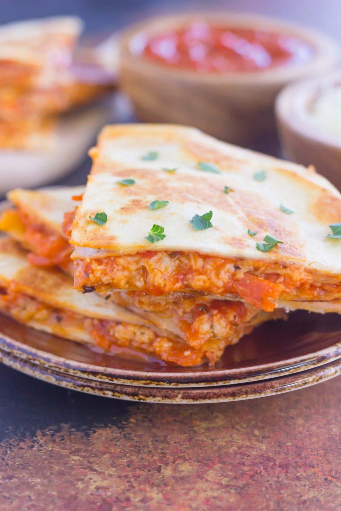 Perfect for a Friday night or anytime that want a quick meal, these Easy Pizza Quesadillas are sure to become a regular on your meal rotation! #pizza #quesadillas #pizzaquesadillas #pizzarecipes #pizzaappetizers #appetizer #snack #recipe