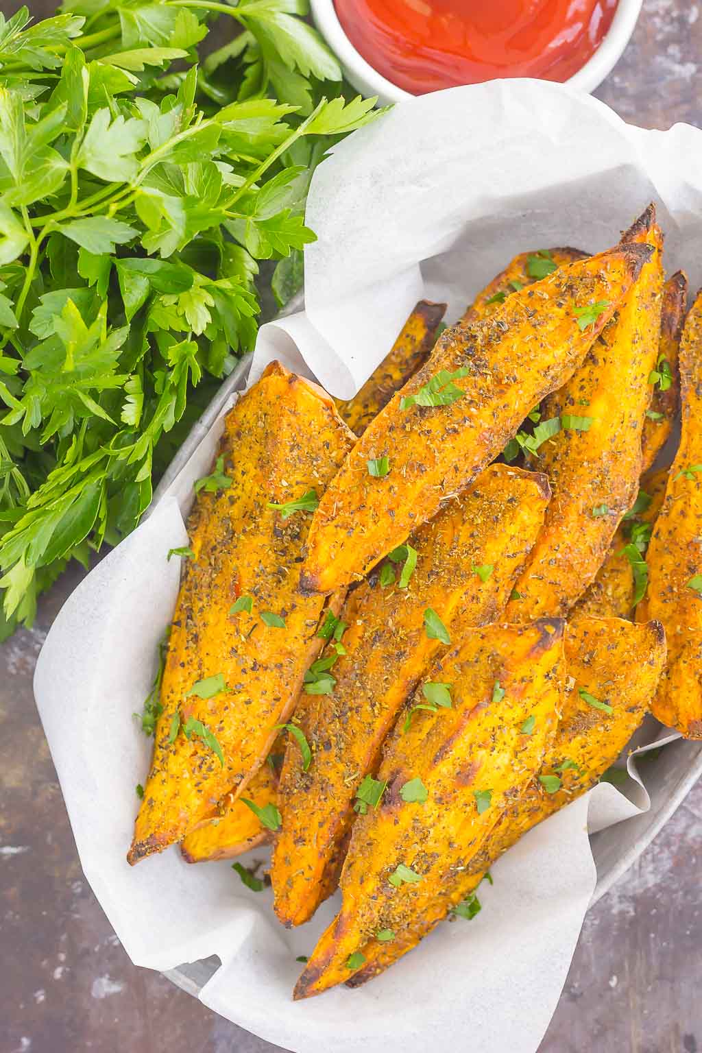 These Garlic Herb Sweet Potato Wedges are loaded with flavor and baked until crispy and golden. Made with just a few simple ingredients and ready in no time, these wedges are the perfect side dish for just about any meal!