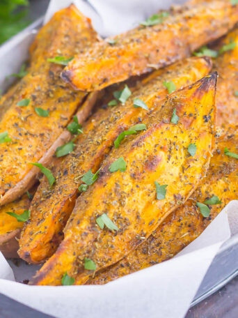 These Garlic Herb Sweet Potato Wedges are loaded with flavor and baked until crispy and golden. Made with just a few simple ingredients and ready in no time, these wedges are the perfect side dish for just about any meal!
