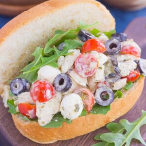 This Italian Chicken Salad is fresh, easy, and bursting with flavor. Loaded with mozzarella cheese, tomatoes, black olives and pesto, this fun twist on a classic flavor will have you coming back for more. This salad is perfect for an easy lunch or dinner and makes delicious sandwiches, too!