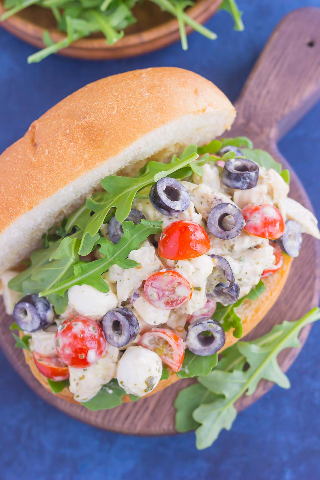 A sub roll filled with Italian pesto chicken salad. 