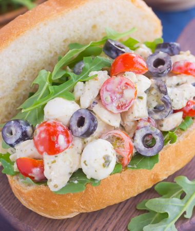 This Italian Chicken Salad is fresh, easy, and bursting with flavor. Loaded with mozzarella cheese, tomatoes, black olives and pesto, this fun twist on a classic flavor will have you coming back for more. This salad is perfect for an easy lunch or dinner and makes delicious sandwiches, too!