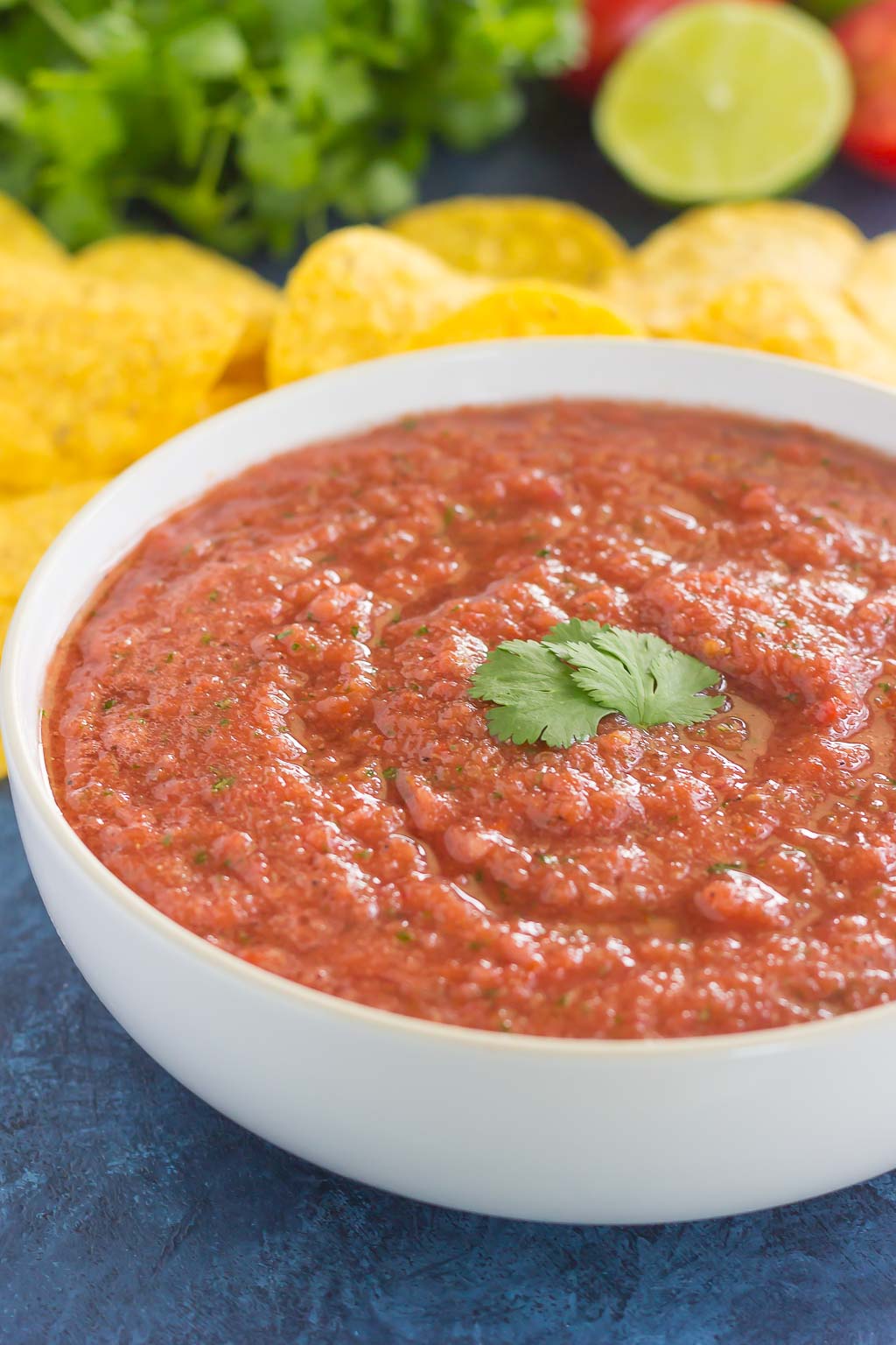 restaurant style salsa in white bowl next to tortilla chips