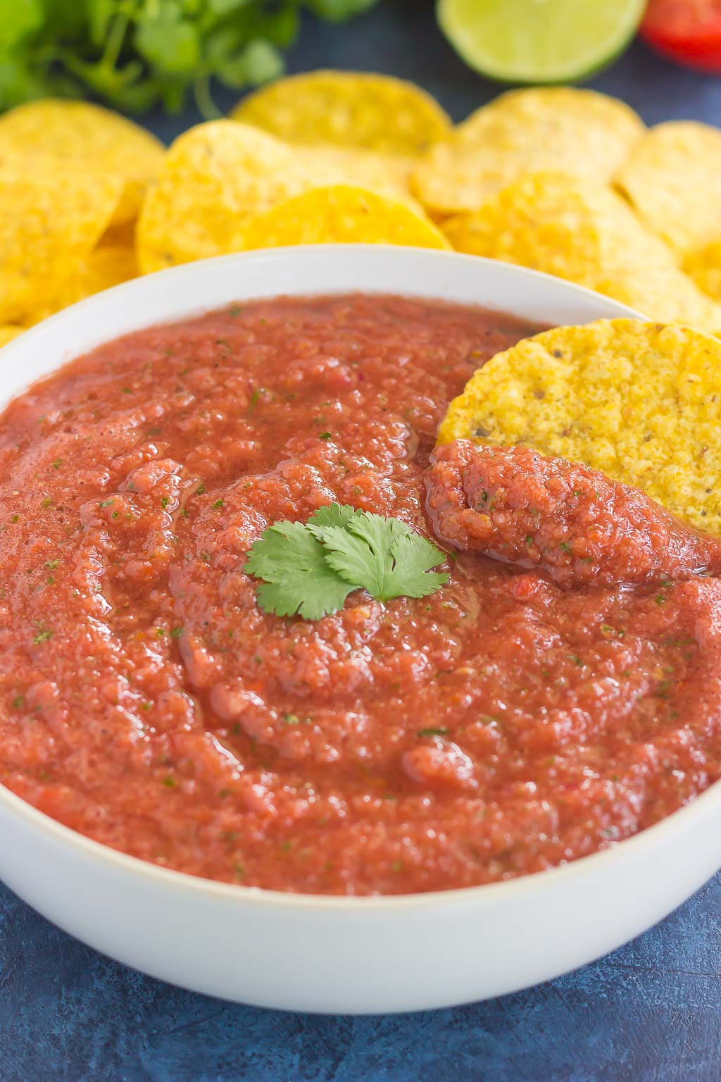 restaurant style salsa with tortilla chip dunked in it