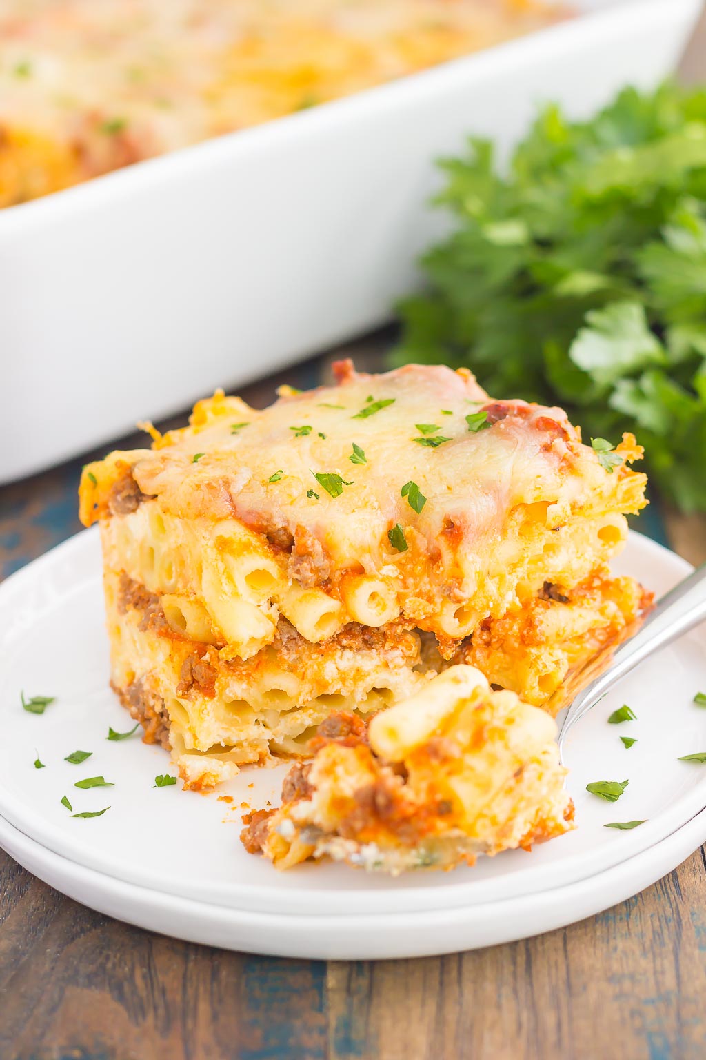 This Easy Baked Ziti is made with simple ingredients, full of flavor, and ready in less than an hour. Loaded with an easy meat sauce, tender pasta, and three types of cheese, this comfort dish is sure to be a dinnertime crowd-pleaser!