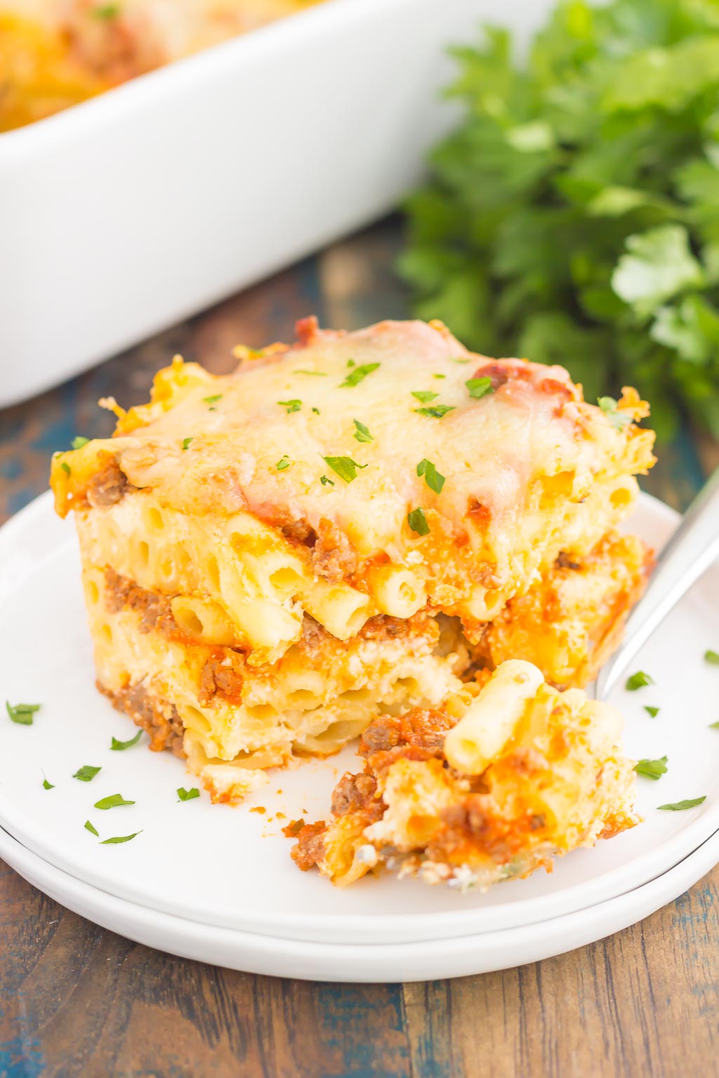 This Easy Baked Ziti is made with simple ingredients, full of flavor, and ready in less than an hour. Loaded with an easy meat sauce, tender pasta, and three types of cheese, this comfort dish is sure to be a dinnertime crowd-pleaser!